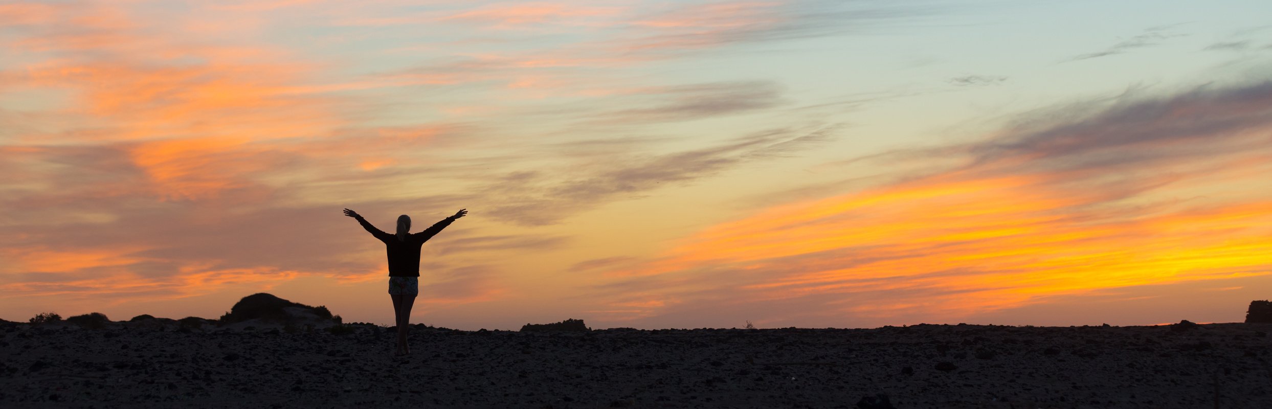 Woman Enjoying Freedom at Sunset